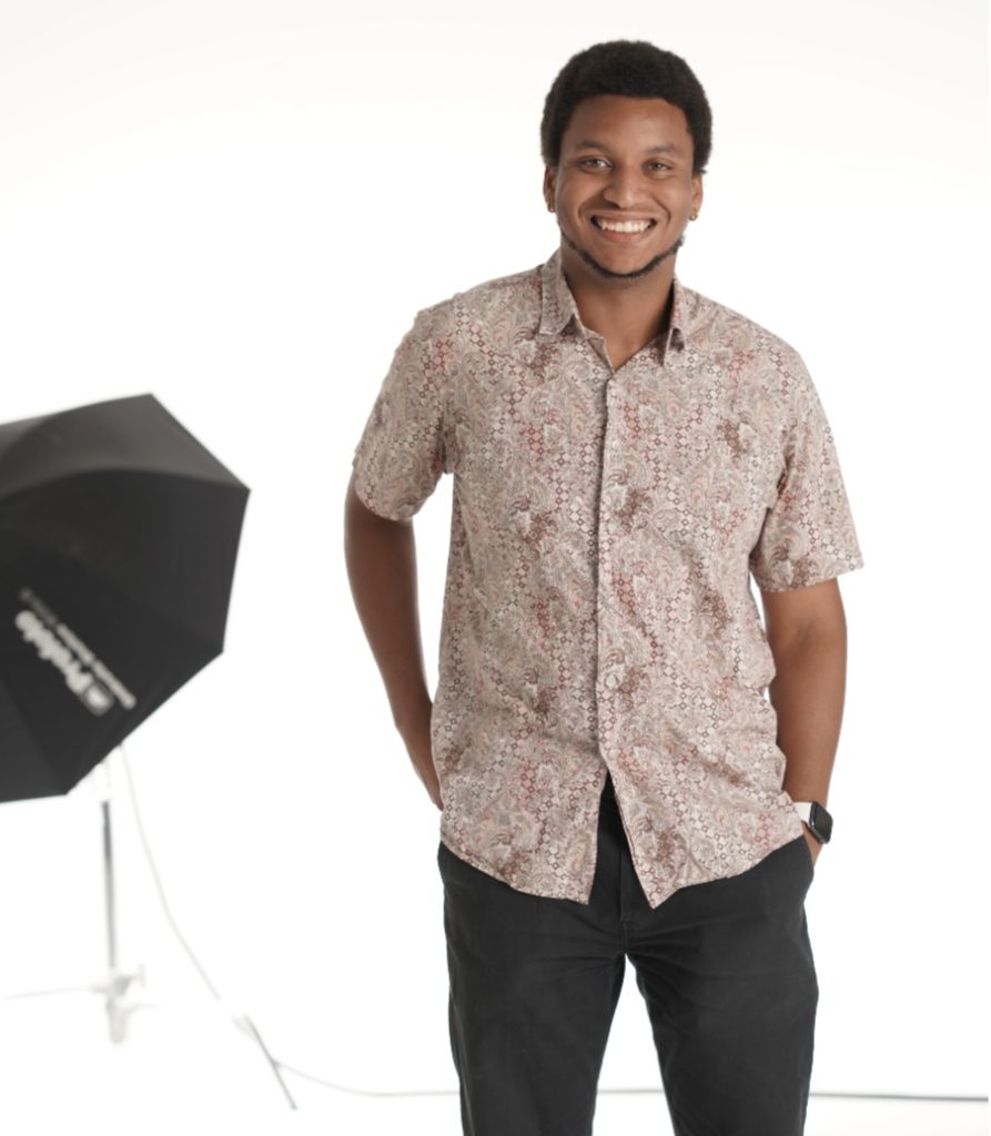 Emmanuel "Manny" Tobe '21 poses by a studio light.