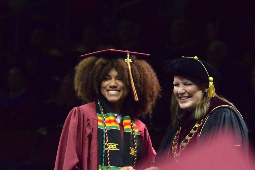 Kendall Saulsby, a cinema and television arts student, poses with President Connie Book at Commencement.