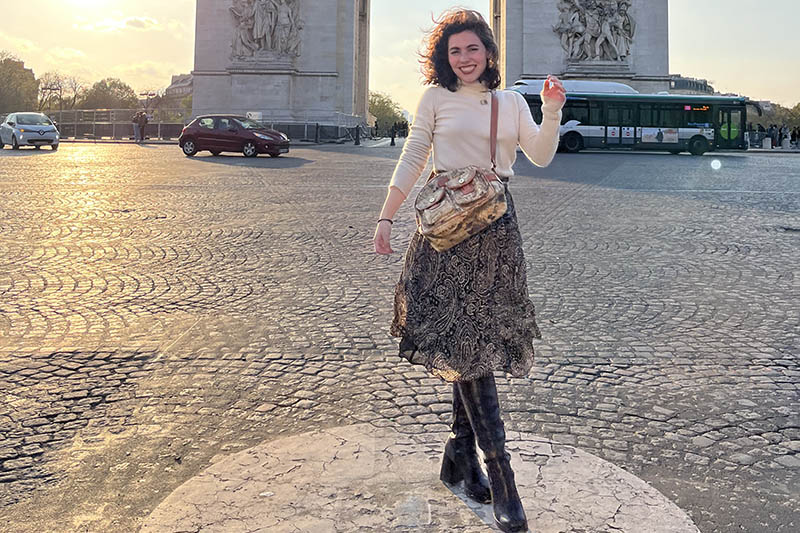 Isabel Zory stands on cobblestone in France.