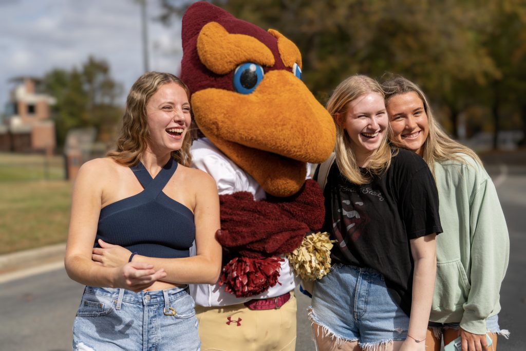Students posing with the Phoenix during Homecoming.