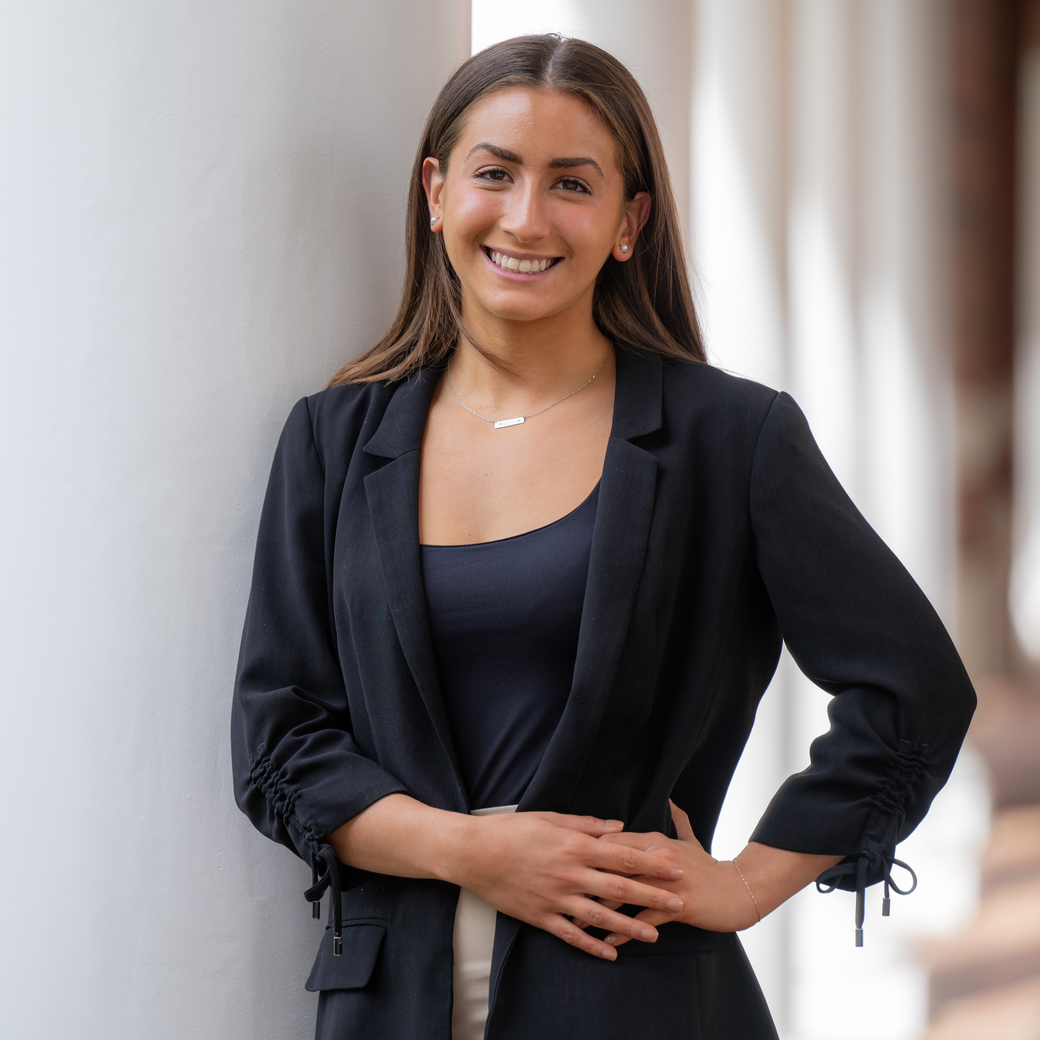 Elon prepared students like Ava Rosen, who is wearing a blue blazer and standing outside, with success after graduation.