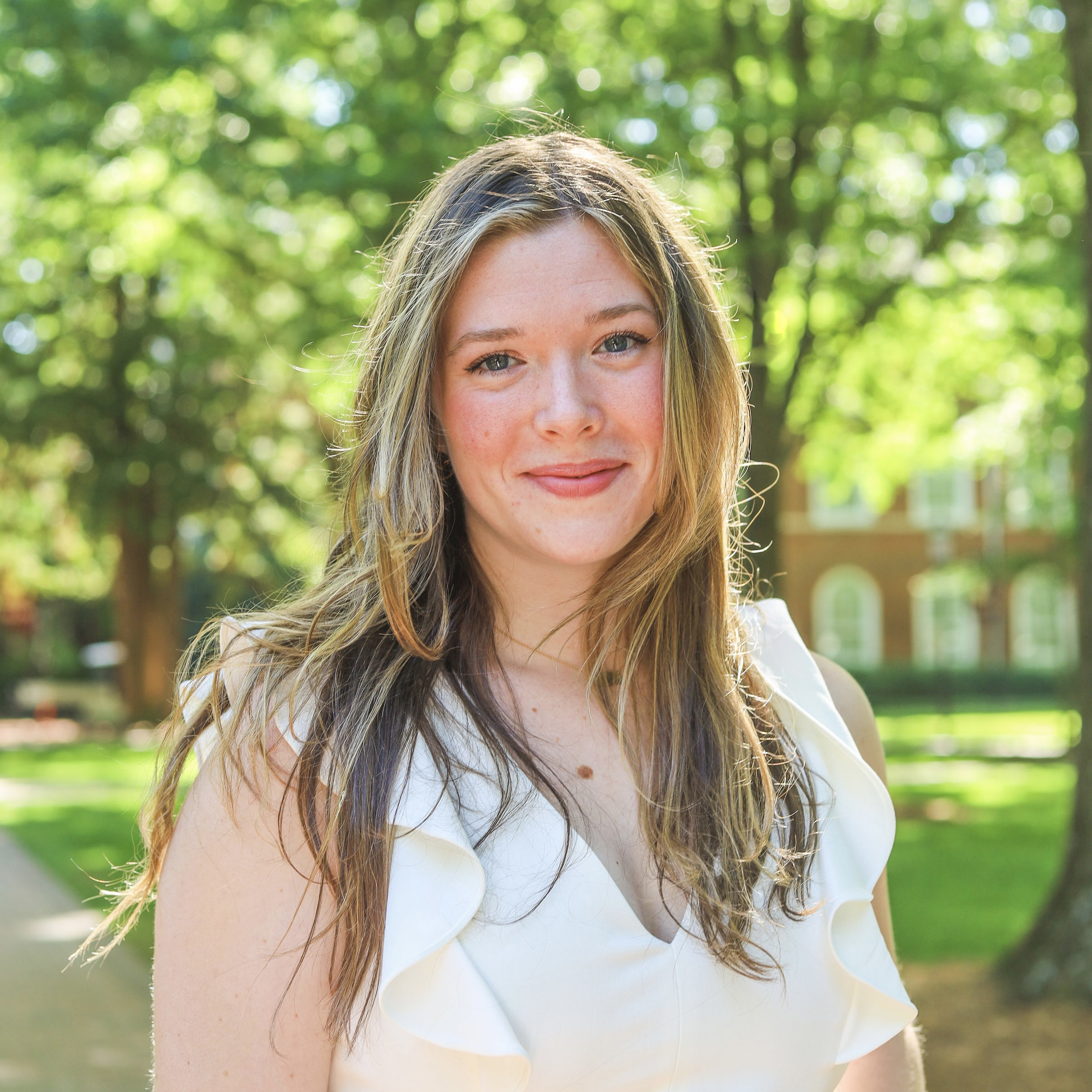 Elon's excellent degree outcomes helped Justine Hurst, who is standing outside on Elon's campus, secure a position as a MedFellow.