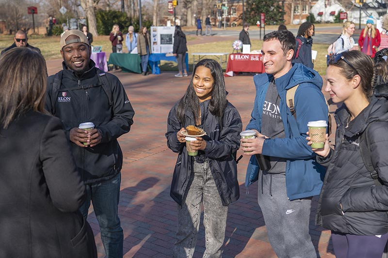 Four students enjoy coffee and pastries at College Coffee on Phi Beta Kappa Commons.