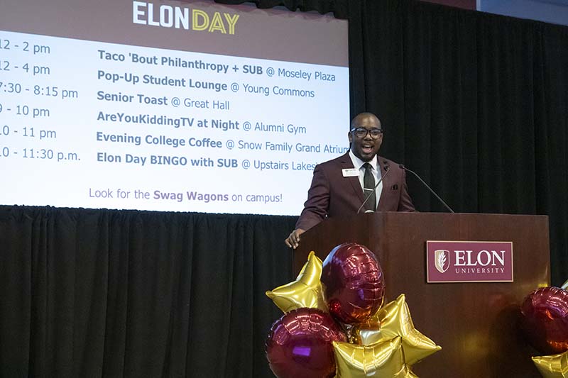 Britt Mobley, who as SGA President holds a leadership role as part of Elon University's experiential learning programs, stands at a podium giving a speech.