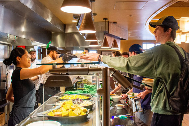 People serving food at McEwen Dining Hall.