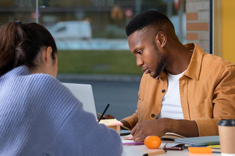 A Black male is seeking guidance from a female mentor.