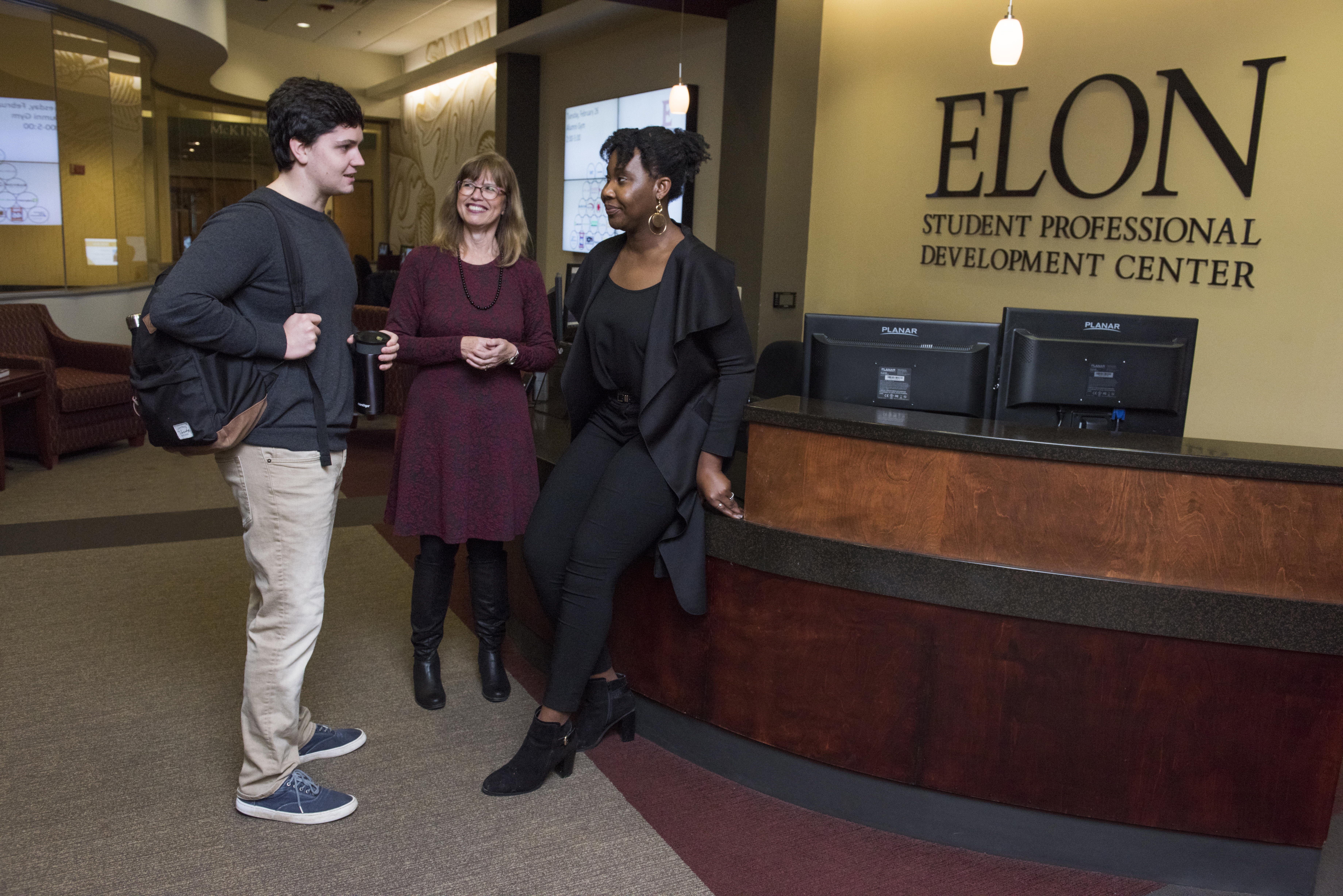 Two students confer with a Student Professional Development Counselor.