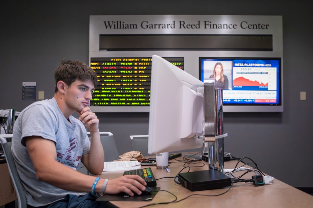 A student works at a terminal in the William Gerrard Reed Finance Center.