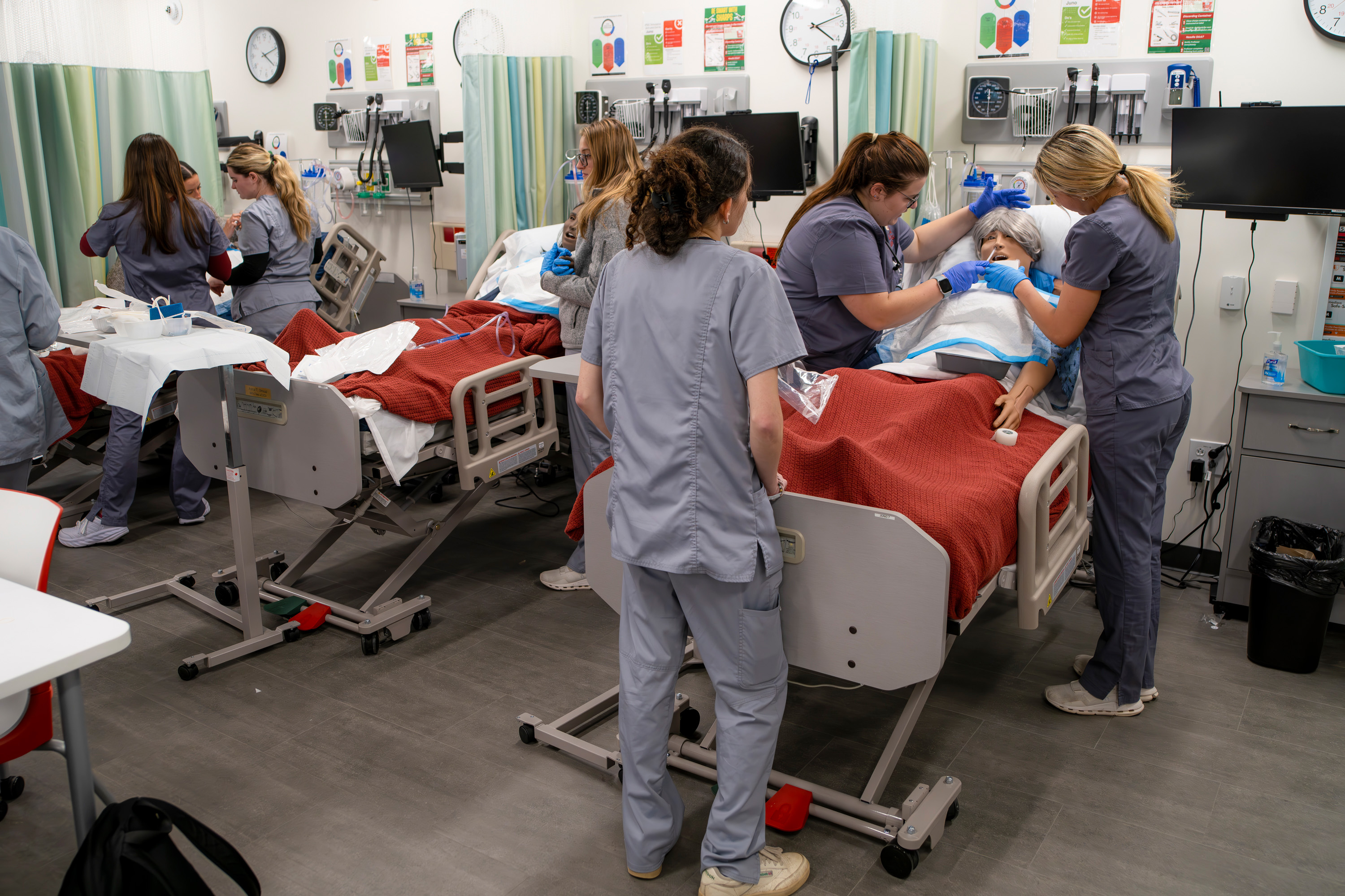 Nursing students work with medical mannequins in the simulation center in the School of Health Sciences.