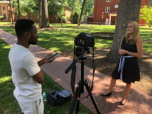 A Queens University student interviews a staff member