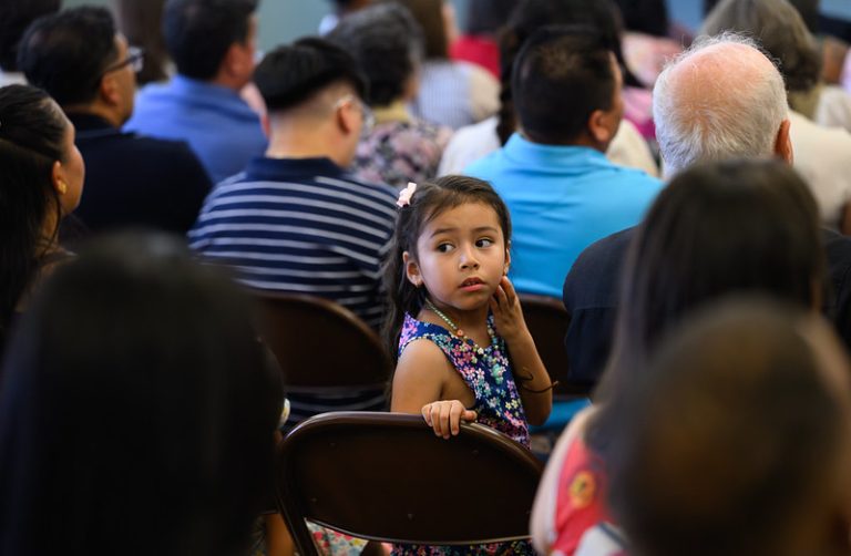 little kid sitting in an audience