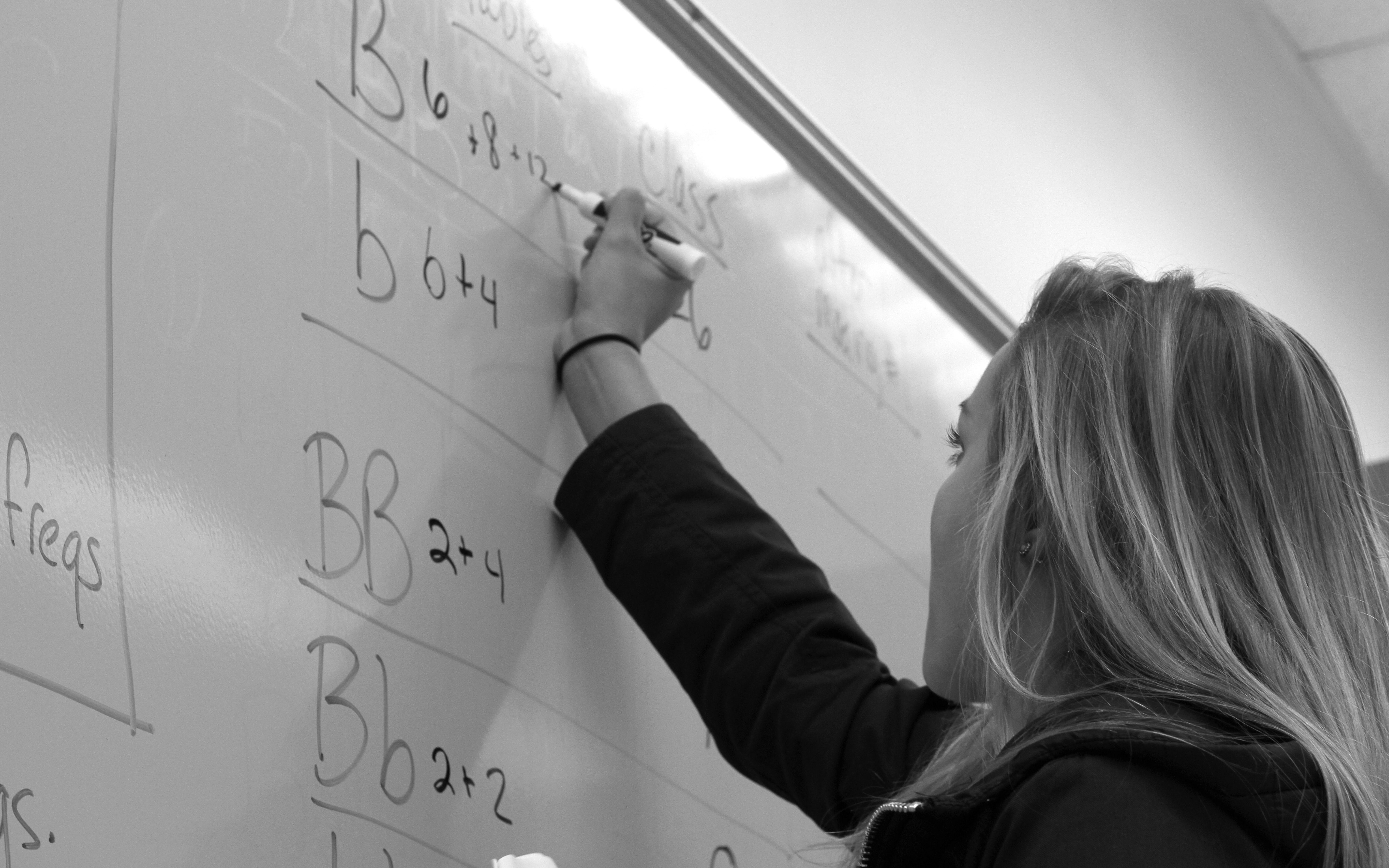 Student writes out formulas on whiteboard