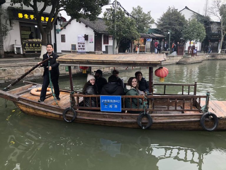 elon mba students on a small canal boat for a study abroad trip