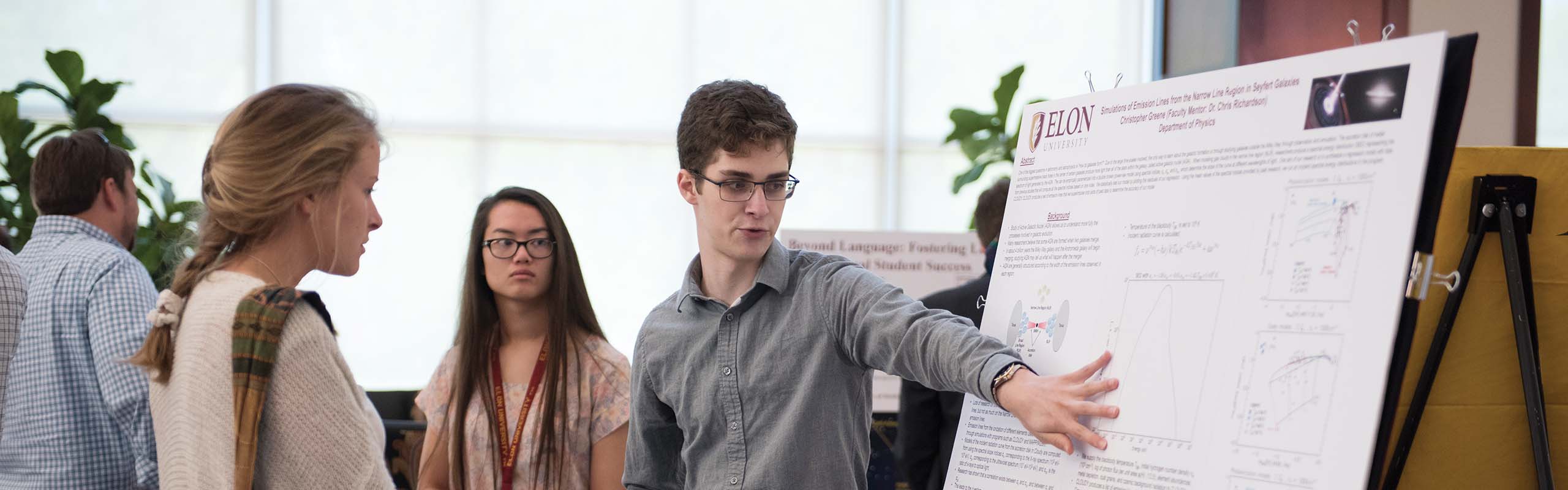Christopher Greene '17, a physics and music double major, presents a poster of his research with Chris Richardson at the Spring Undergraduate Research Forum, SURF.