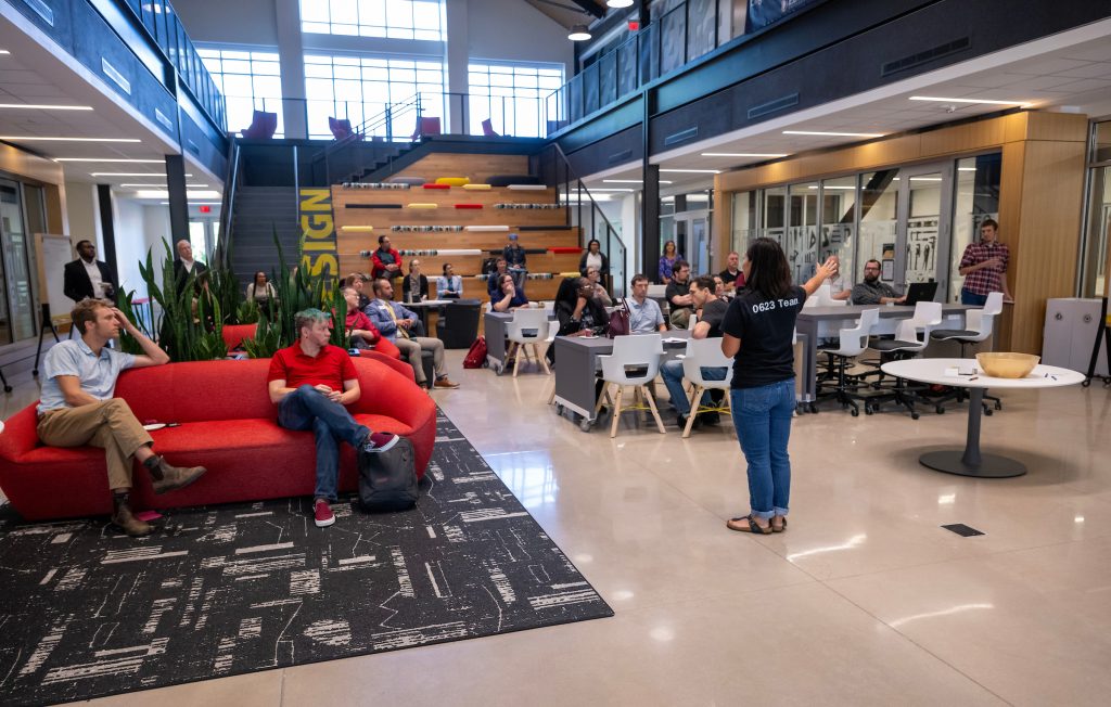 A professor leads a seminar for faculty and staff in Hunt Atrium