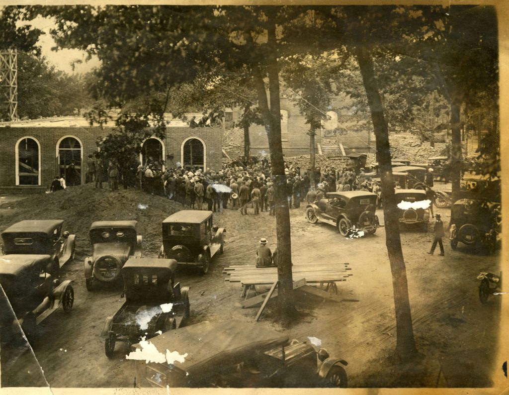 Sepia tone scan of a historic photograph of laying of the cornerstone for Alamance Building in May 1923.