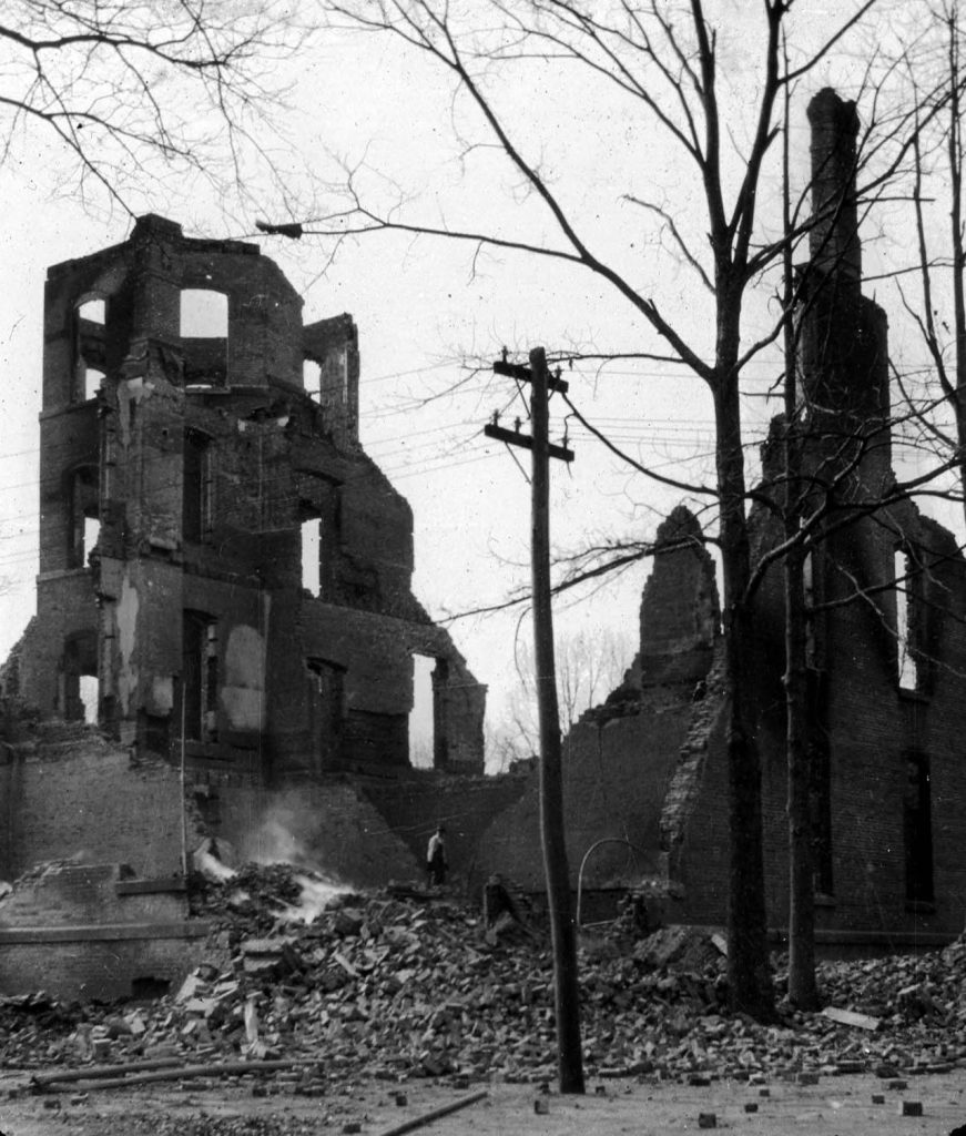 Black and white scan of a historic photograph of the Elon College Administration Building after it was destroyed by a fire.