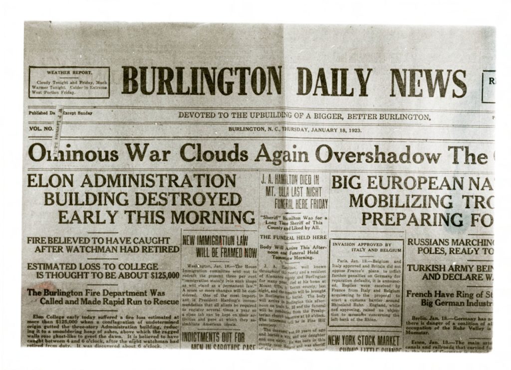 Sepia tone scan of the front page of the January 18, 1923 edition of the Burlington Daily Newspaper showing the headling "Elon administration building destroyed early this morning."
