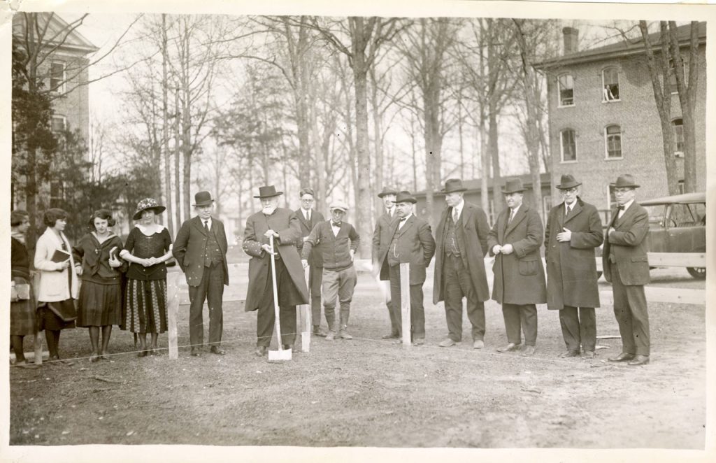 Sepia tone scan of a historic photograph of Elon College officials breaking ground for Alamance Building on March 21, 1923.
