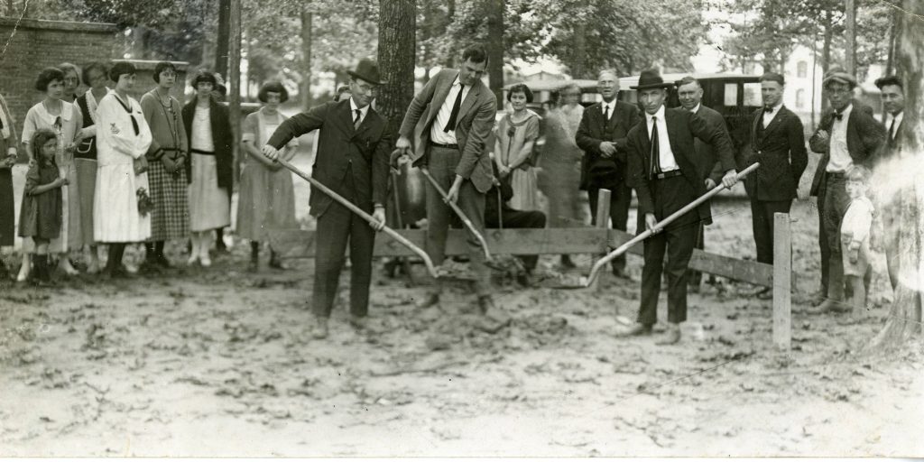 Men with shovels at the groundbreaking for Duke Building