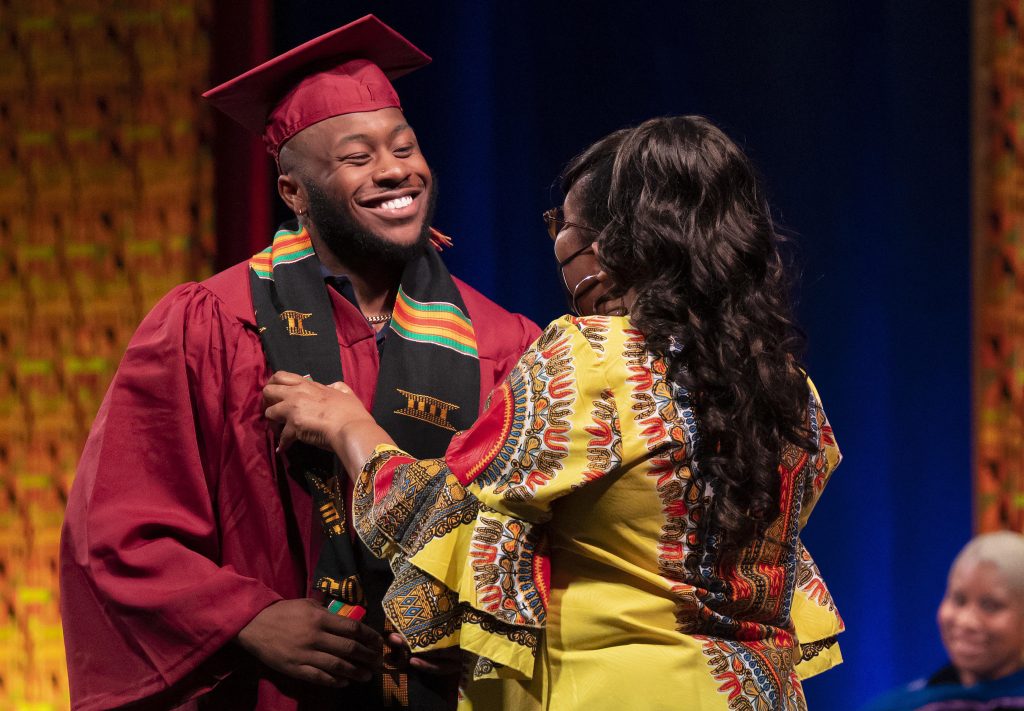 Students participate in the Donning of the Kente ceremony at Alumni Gym on the campus of Elon University. 