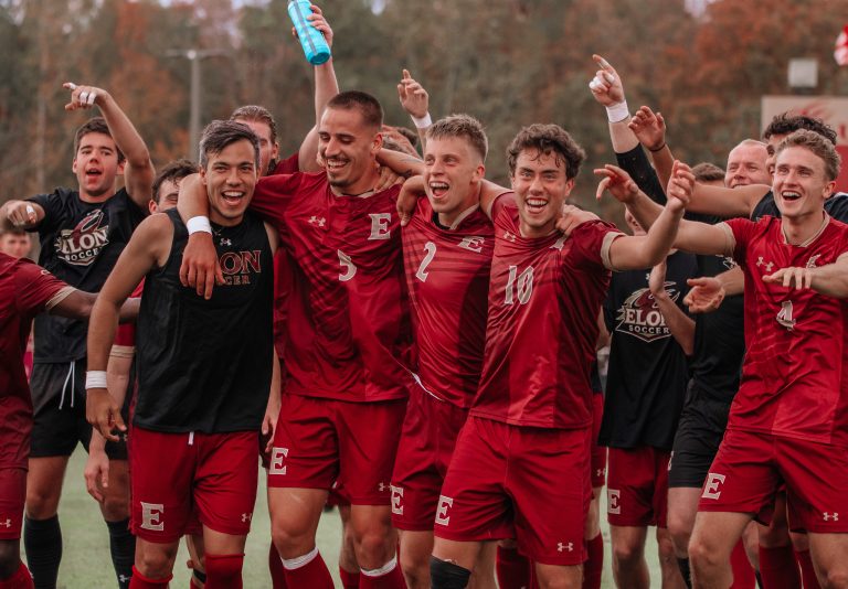 Members of he men's soccer team at Elon University celebrate after a win