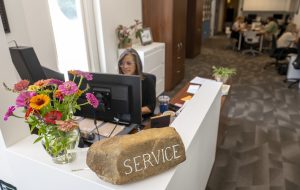 Nicole Bergen at the front desk in the Kernodle Center for Civic Life in the Moseley Center.