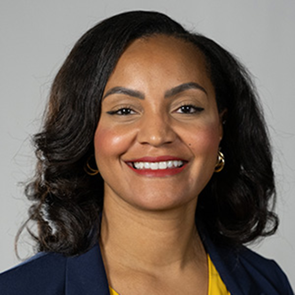 A woman smiling at the camera in a professional headshot