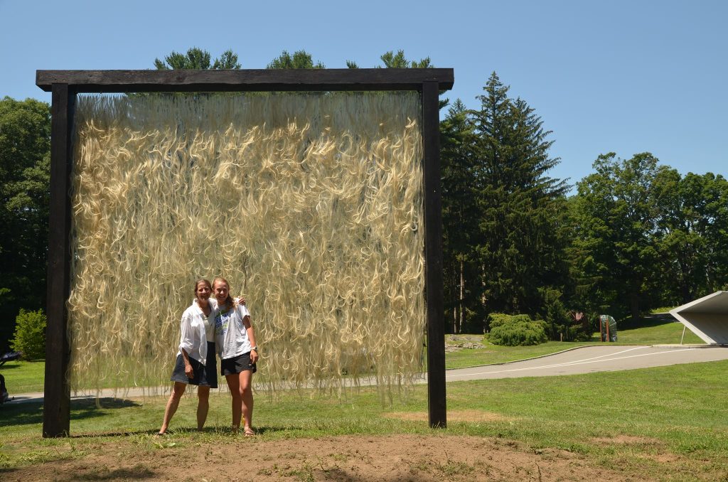 Charlotte Murphy ’19, pictured in front of an installation she helped build while interning with environmental artist Nancy Winship Milliken, focused on Art and Sustainability during her time at Elon. Upon graduation, she continued as Milliken’s studio assistant before earning her teaching license.