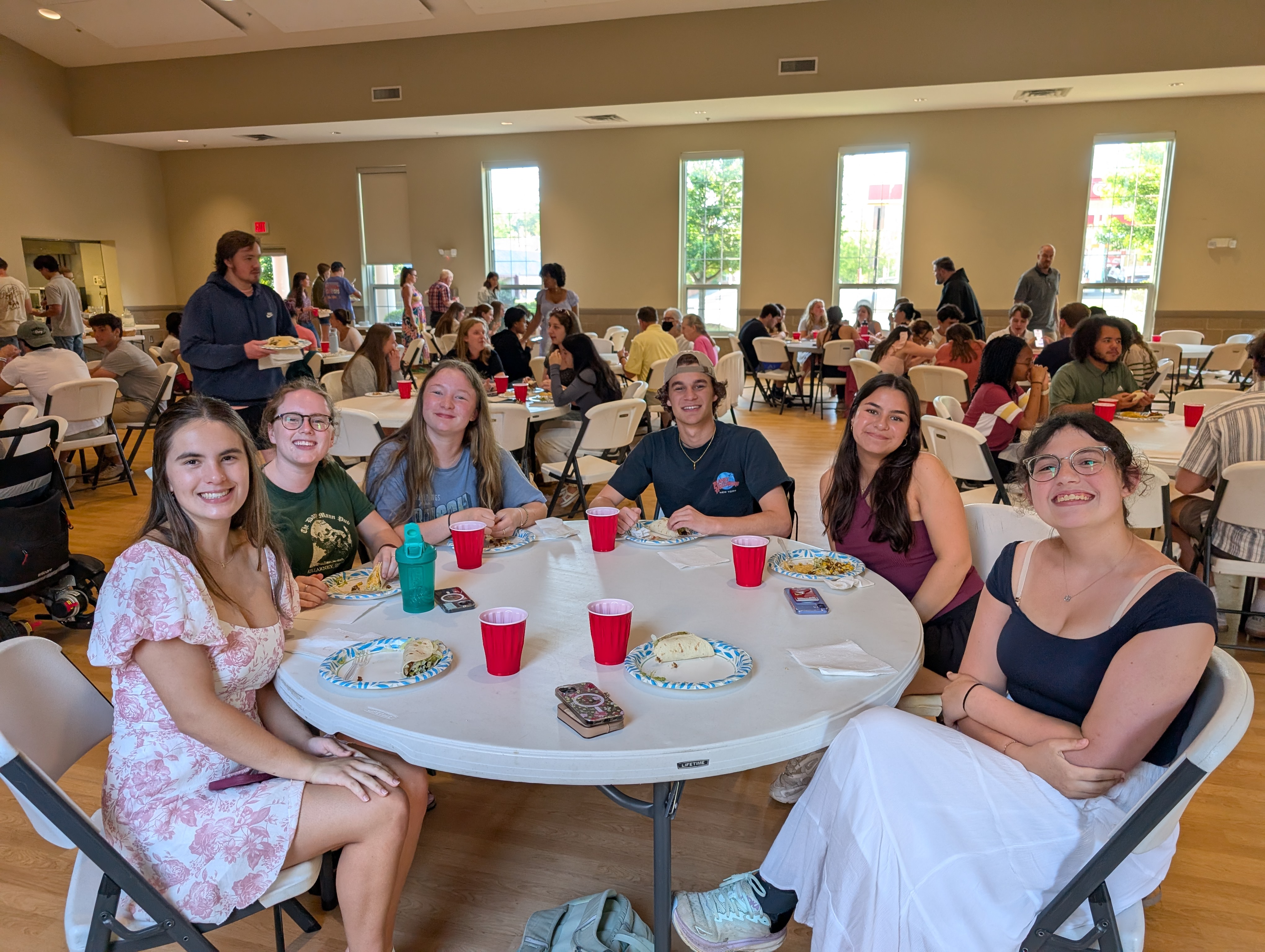 A group of students sharing a meal at the monthly Catholic Life Sunday Supper.