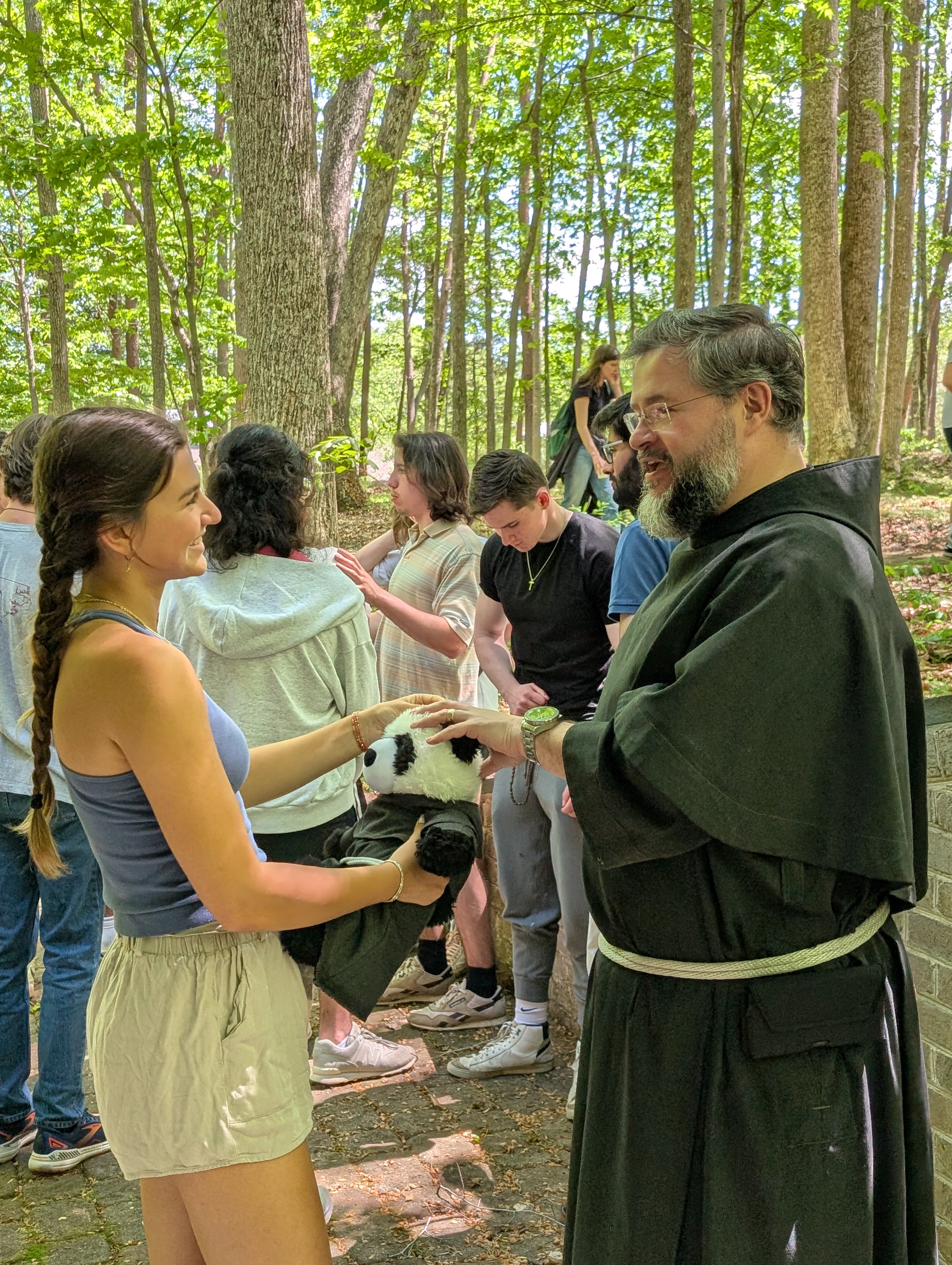 Father Peter talking with a student at a retreat.