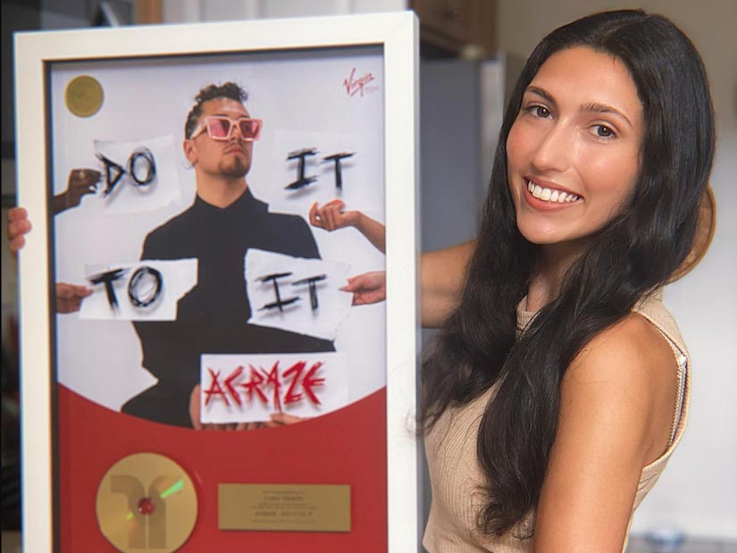 Elon alumna Ciara Graves '20 holding the gold record she received for her work on marketing the hit 'Do It To It.'