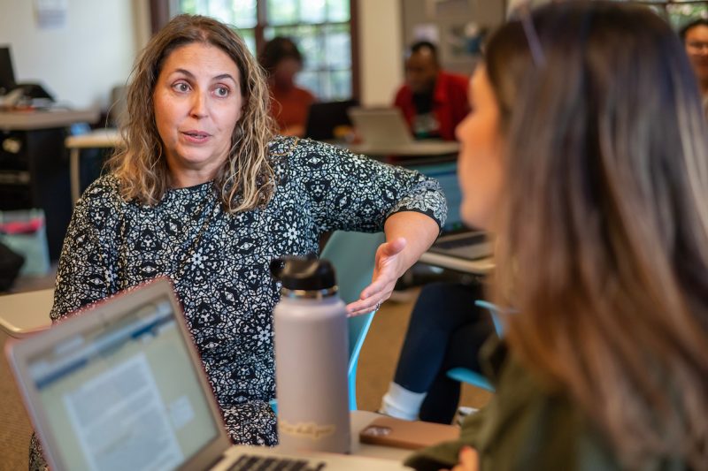 Elon faculty Rozana Carducci talking to an Elon MHE student in a classroom