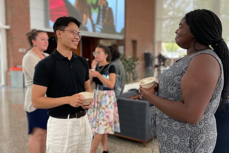 two Elon MHE students talking at a welcome reception