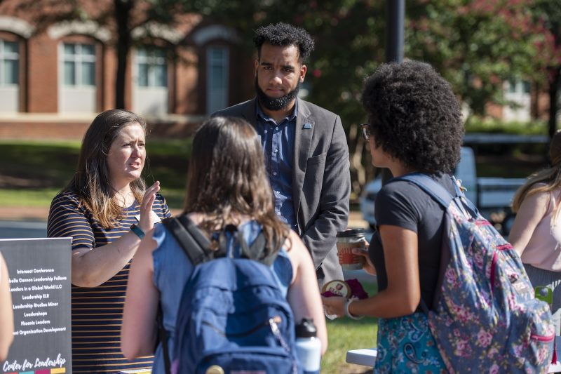 Elon MHE students talking to a faculty member outside in a group