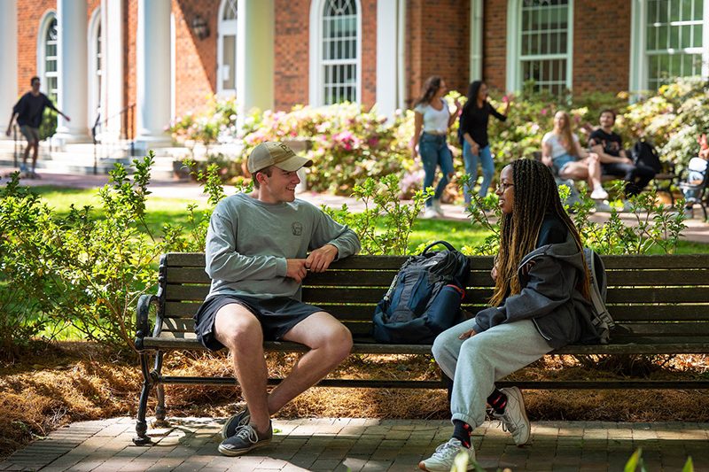 two students sitting on a bench