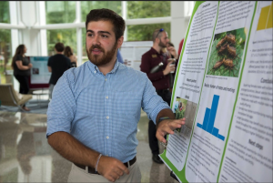 Matt Sears presents a research poster as an undergraduate