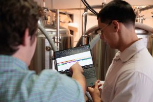 Elon University Students looking at a computer