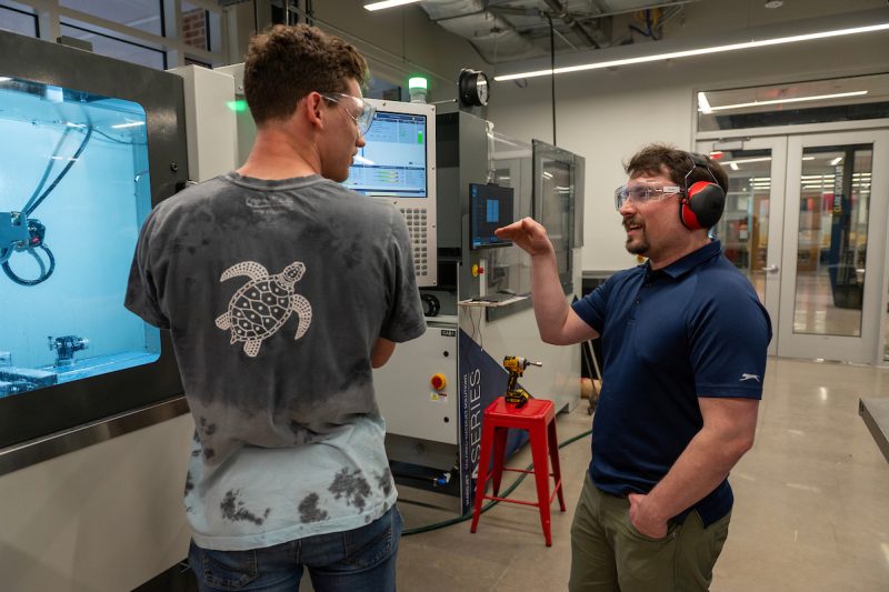 Elon University Students operating machines in Founders Hall