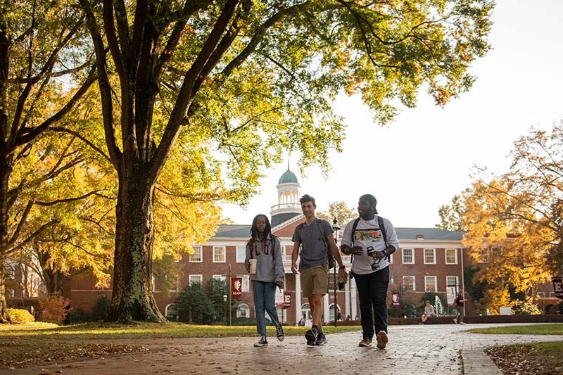 Elon University students walking on central Elon campus