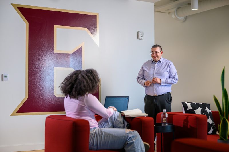 Two people talking in the Elon Charlotte campus
