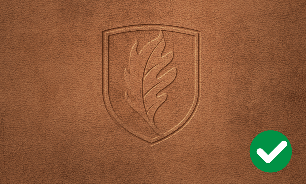 Correct example of Elon University shield embossed on leather.
