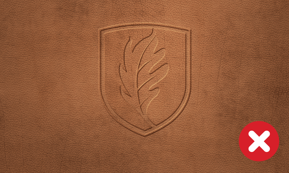Incorrect example of Elon University shield embossed on leather.