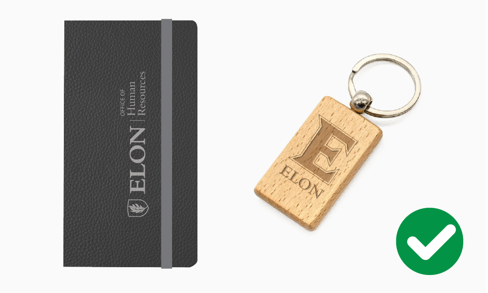 Correct examples of Elon University branding on a black notebook and wooden keychain.