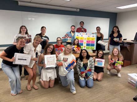 Group of students holding up their activity kits