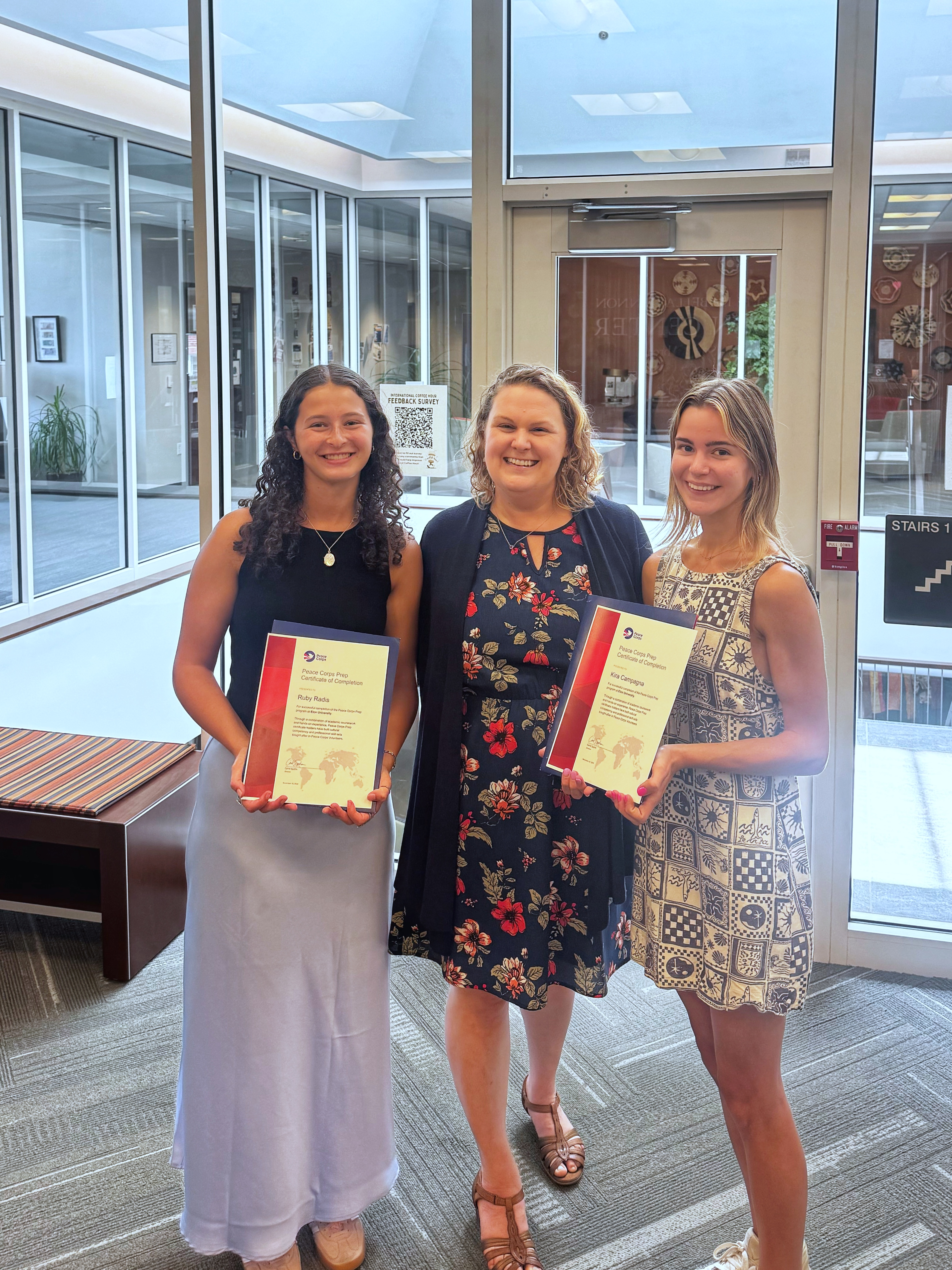 Two students standing with their Peace Corps Prep certificate.
