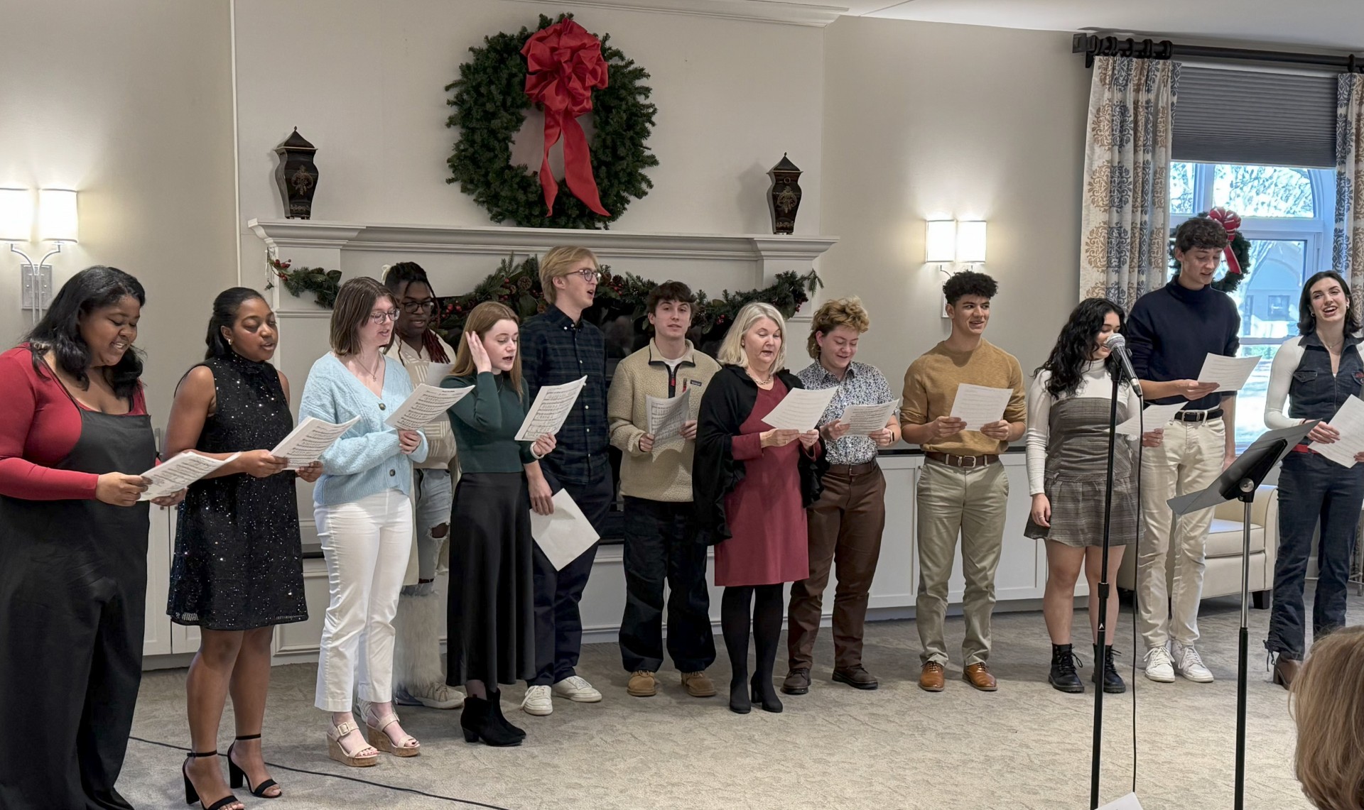 Vocal scholars standing and holding sheet music while they perform.