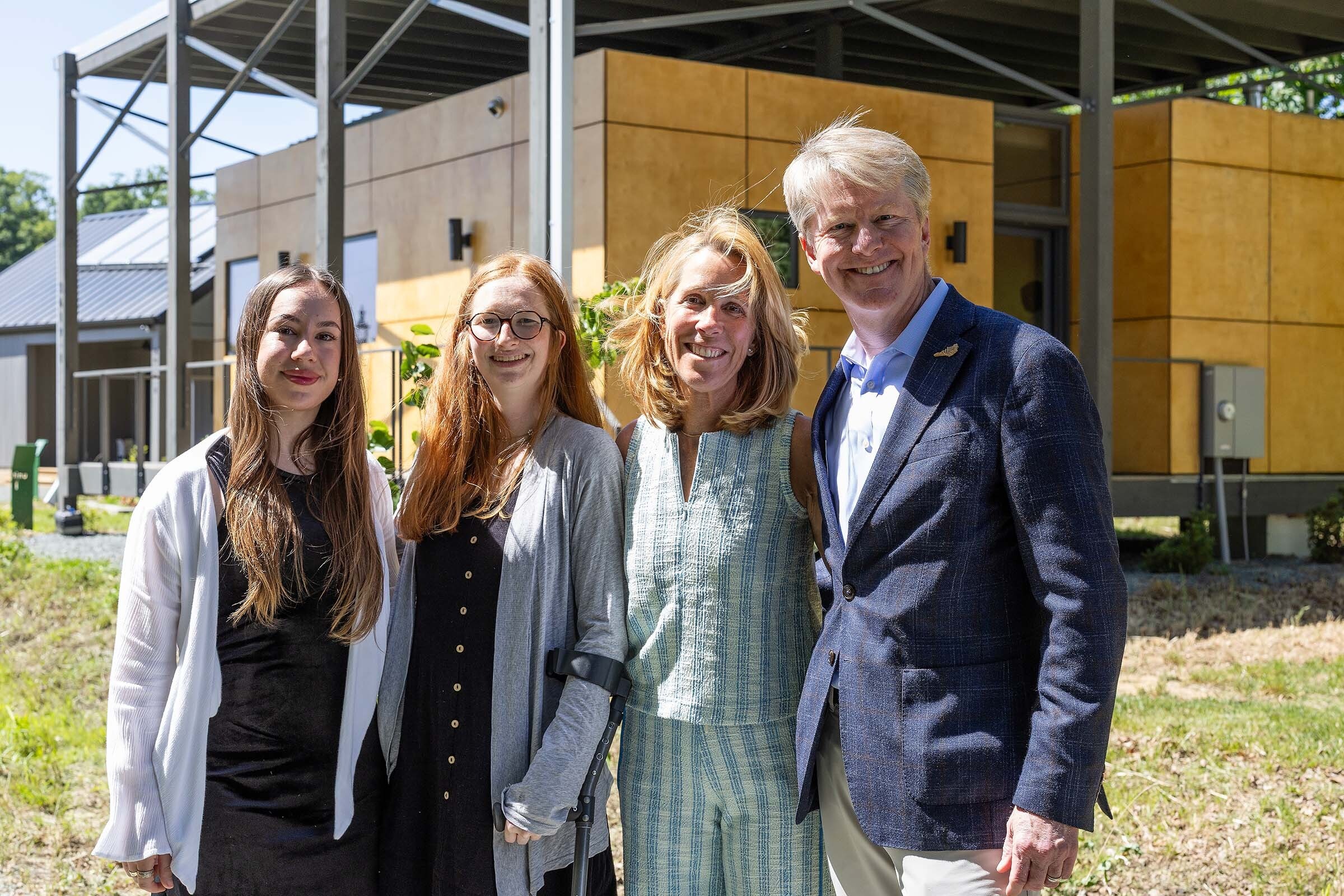 Gloria Kaso ’25, Tate Replogle ’18 and Kristin and John Replogle P’18 in the EcoVillage at Loy Farm.