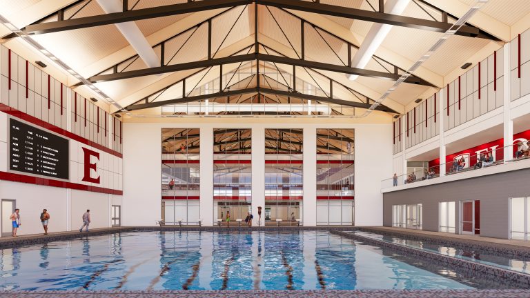 Architectural rendering of the Slattery Center's aquatics facility, showing an indoor lap pool with vaulted ceilings, large windows, a scoreboard, and the Elon "E" logo on the wall.