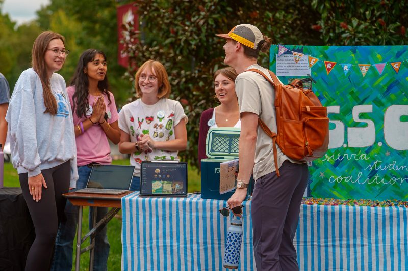 Students laughing at the Sierra Student Coalition table during the Fall Organization Fair.